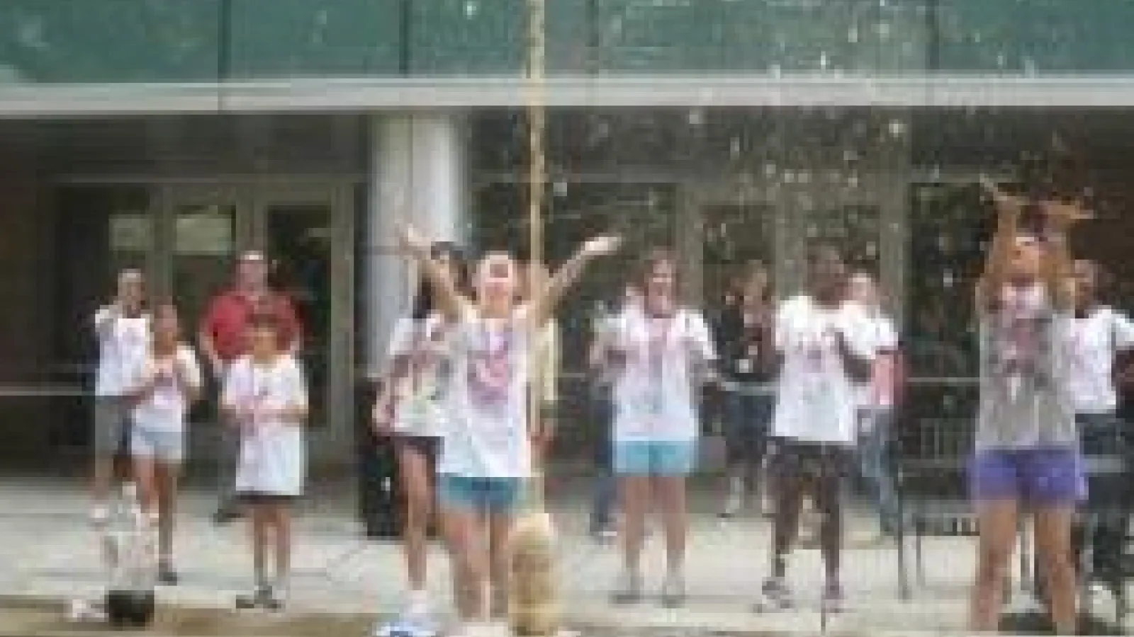 GRASP students doing experiment with soda on the patio of Physics Research Building