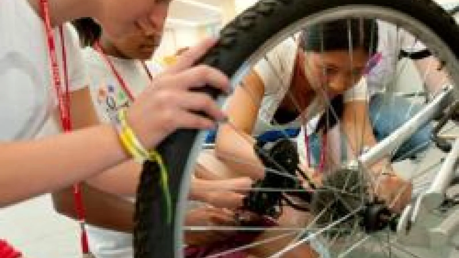Students fixing a bike tire