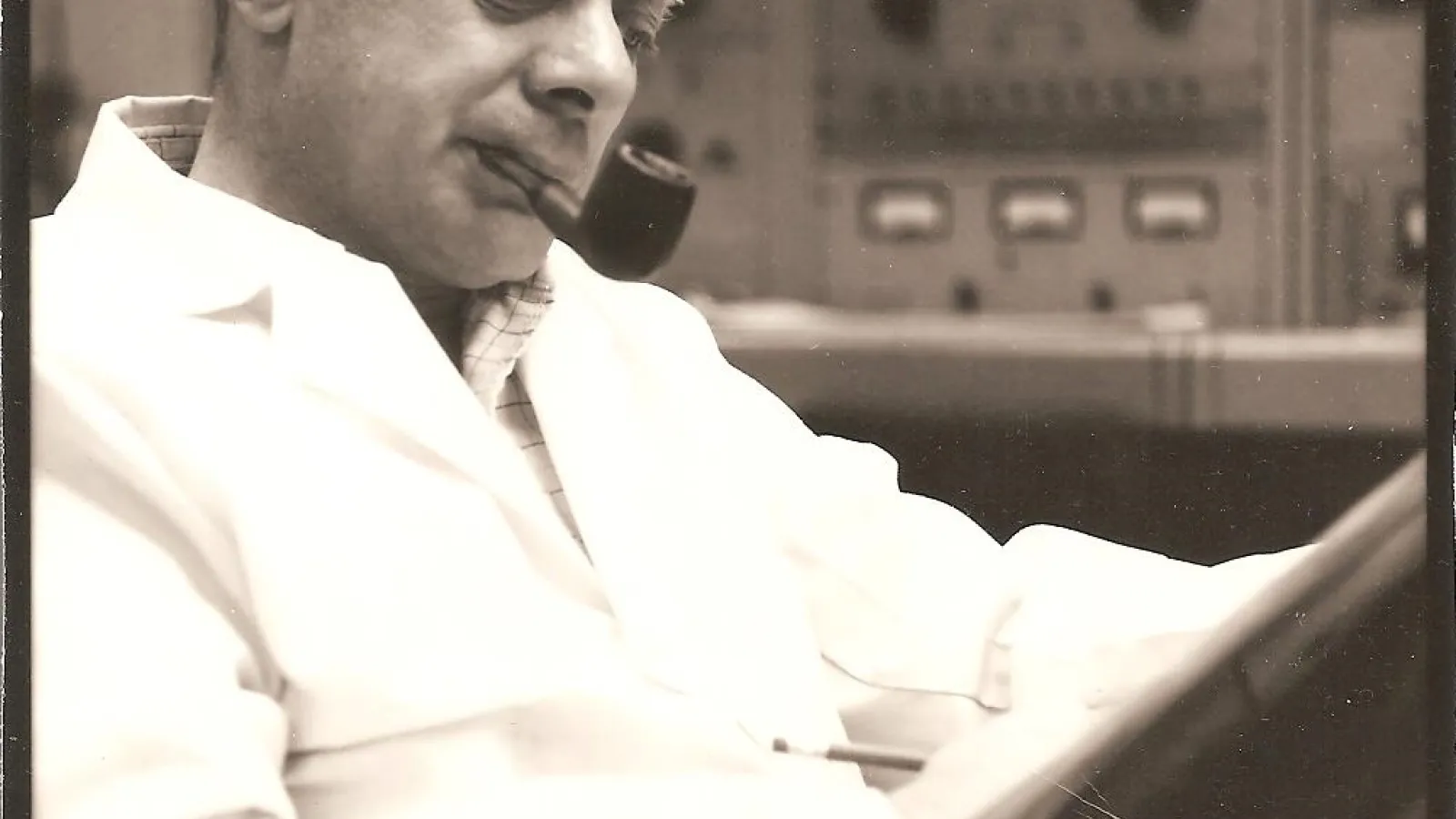 Hersh Hausman reading and smoking a pipe