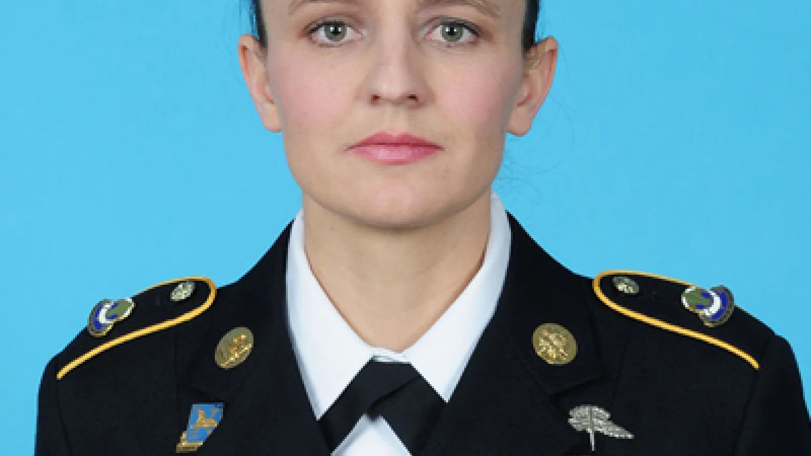 headshot of Khalida Hendricks with a blue background