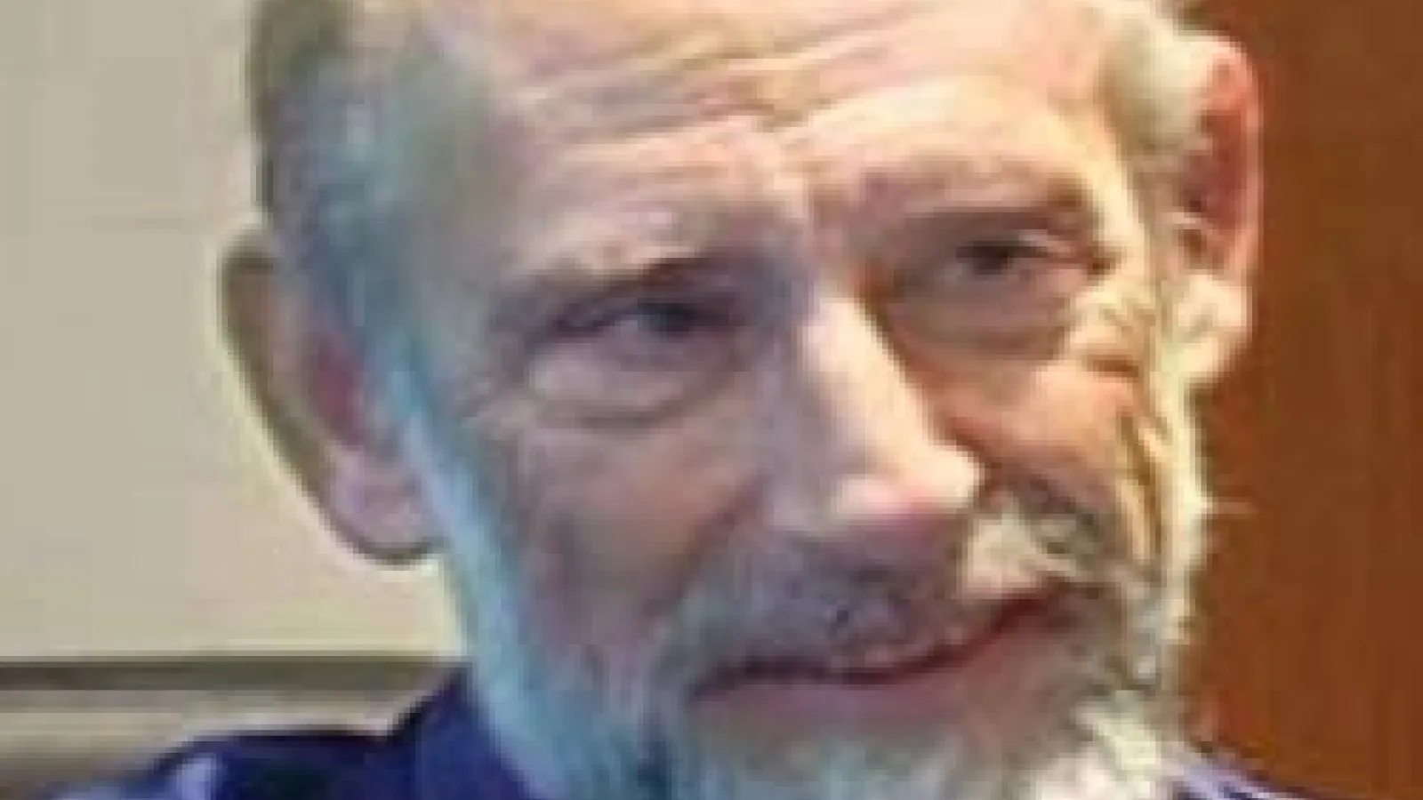 Leonard Susskind smiling and looking off to the side
