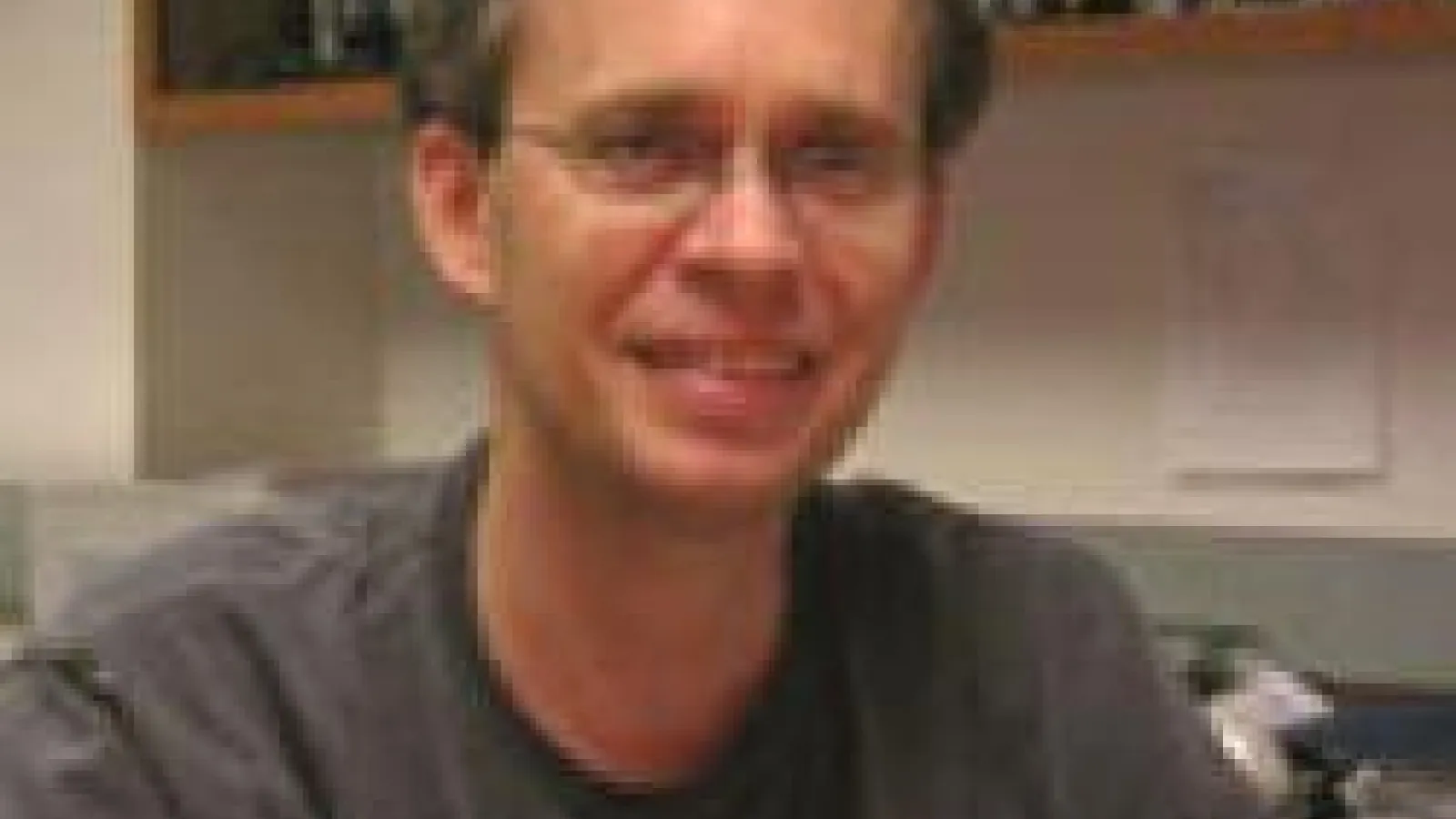 Dmitry Matyushov with bookshelves in the background.