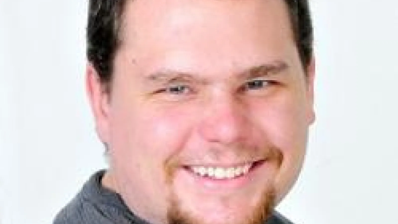 Nicholas Pike smiling with white background