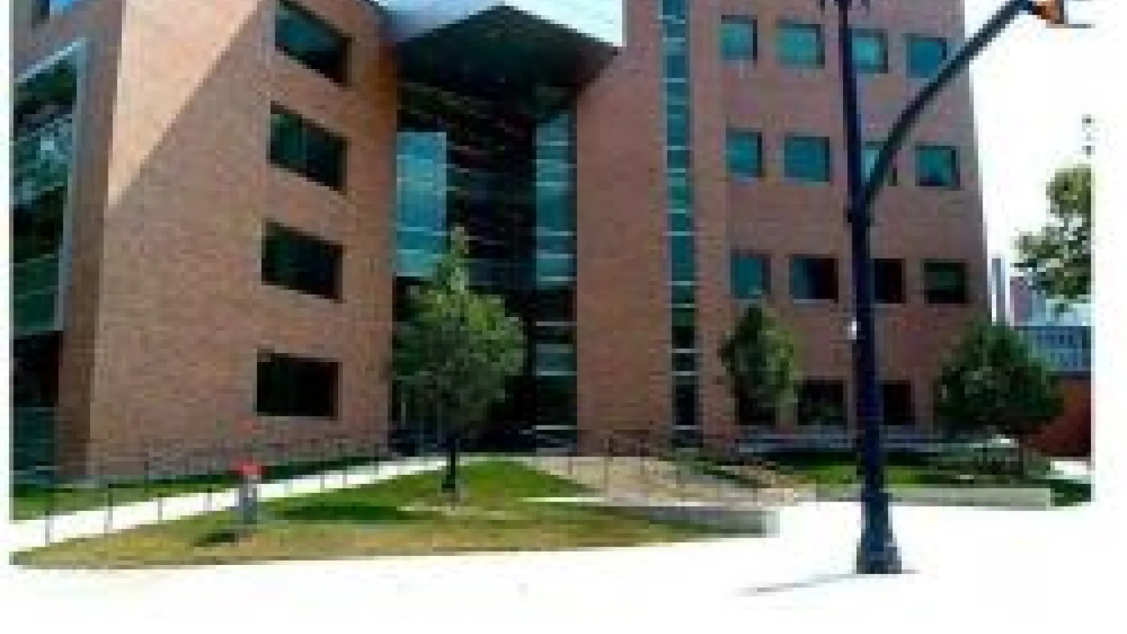 The exterior of the Physics Research Building at The Ohio State University, a multi-story brick building with large windows and a glass entrance.