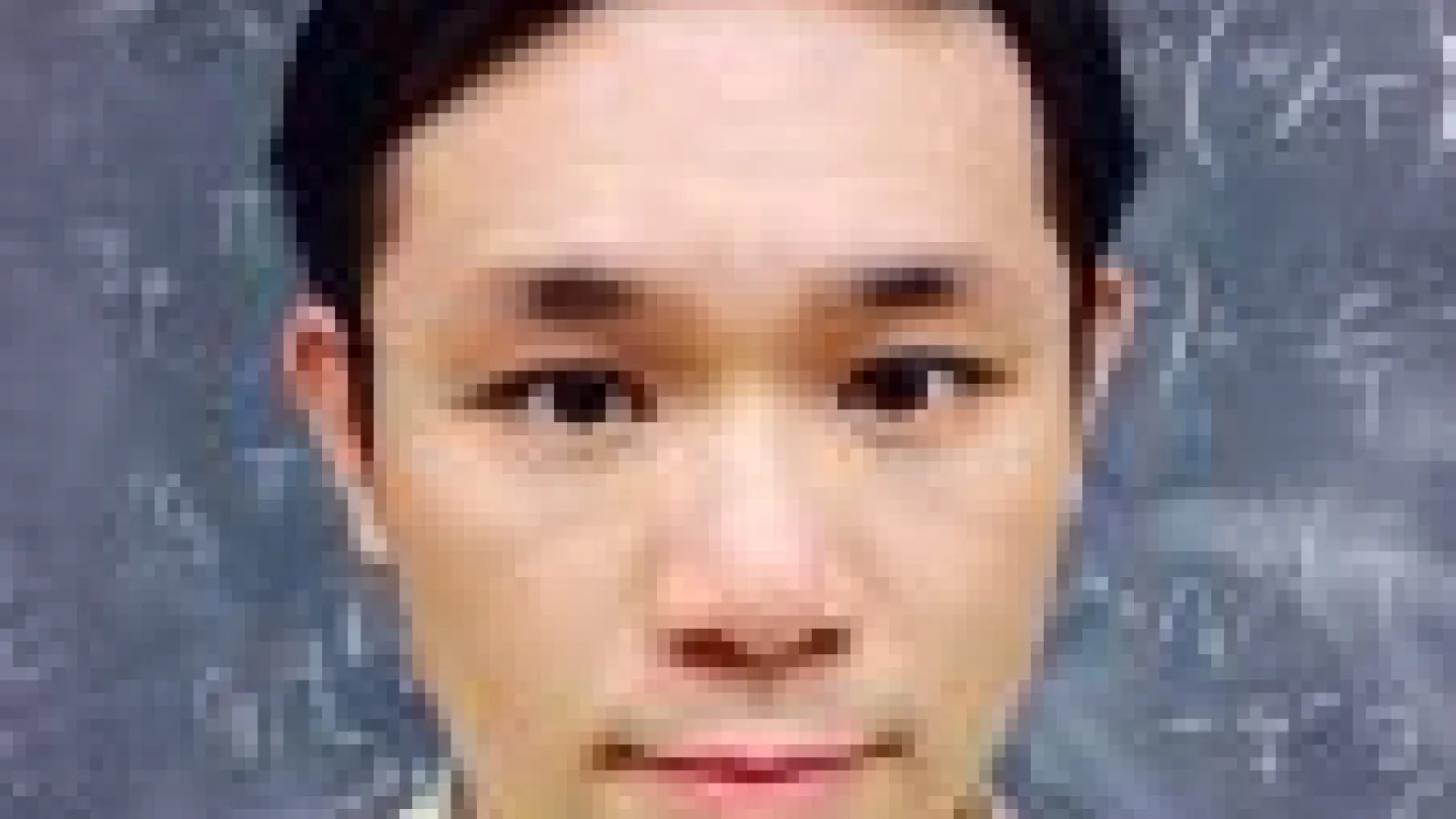 Chun Shen in front of chalkboard