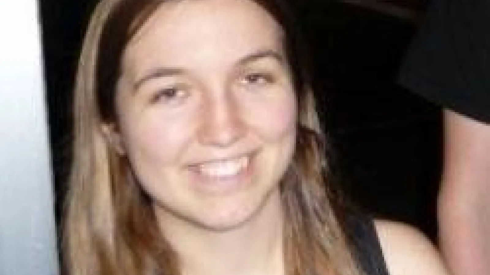 Annika Peter smiling with dark background