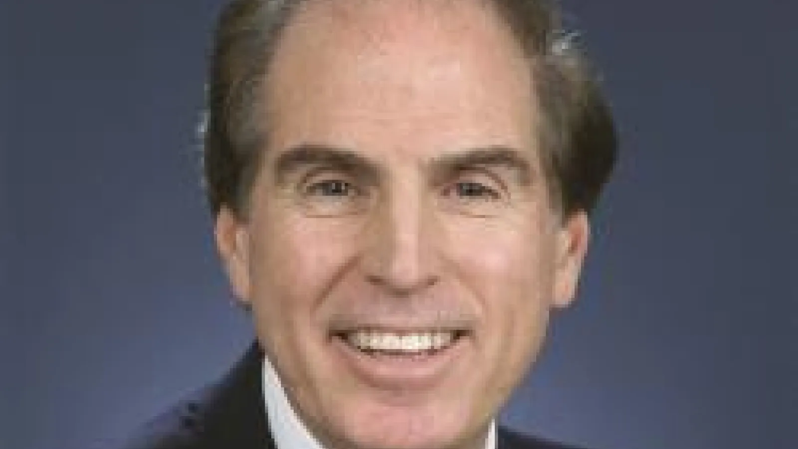 Len Brillson headshot with dark blue background