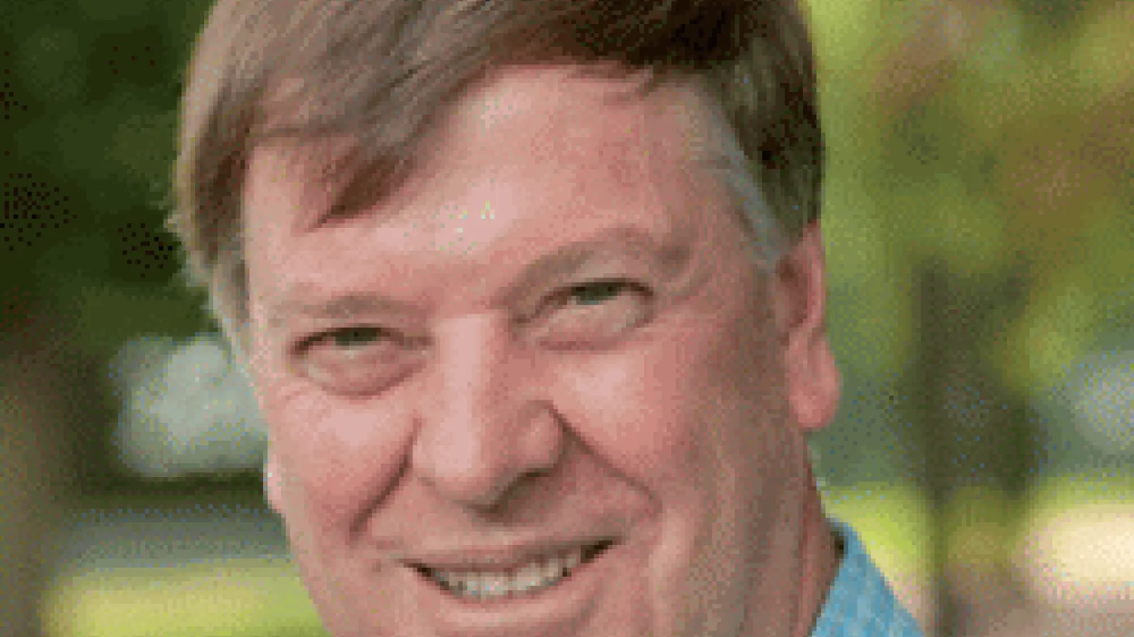 Michael Thackeray smiling with blurred park in the background
