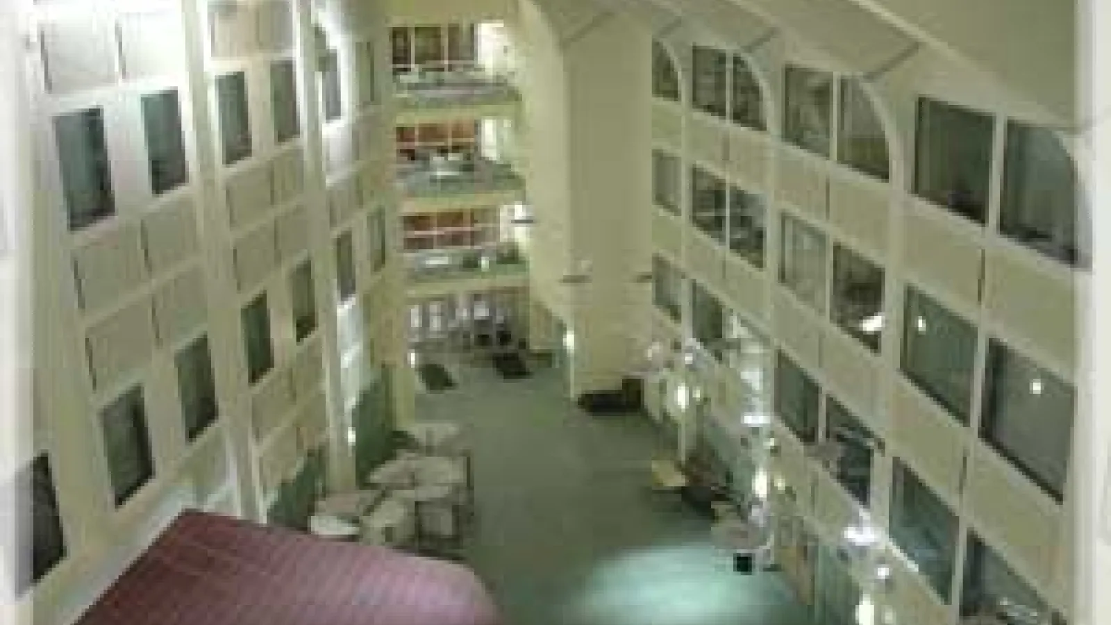 The interior of the Physics Research Building main hallway. On each wall, there are glass windows to offices.