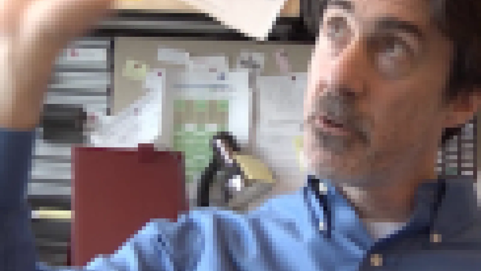Mike Lisa sitting at his desk and gesturing broadly
