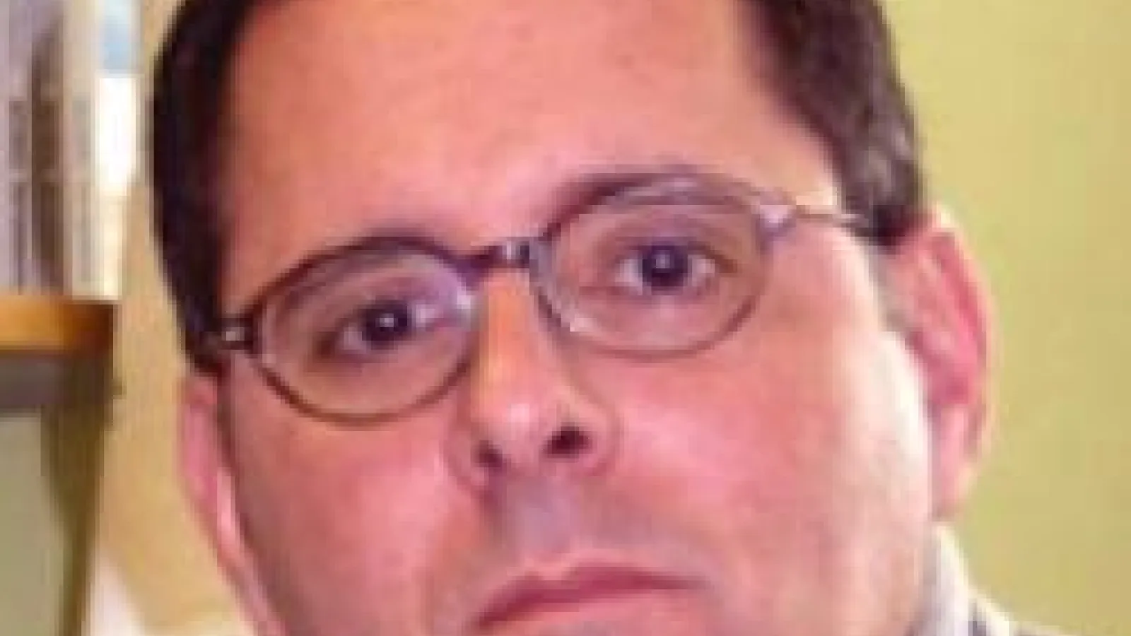 Professor Lou DiMauro against yellow background