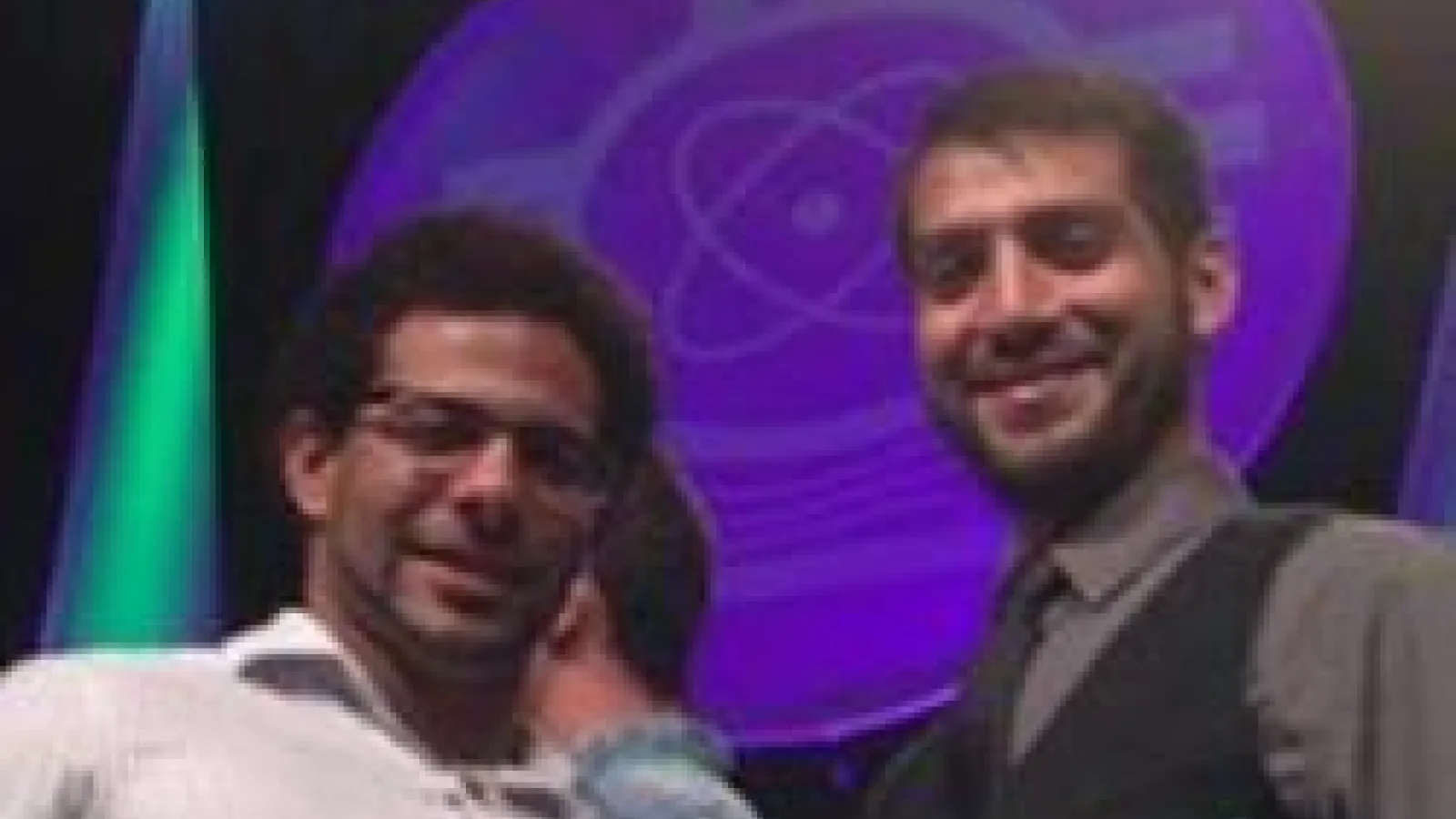 Two students smiling and holding certificates