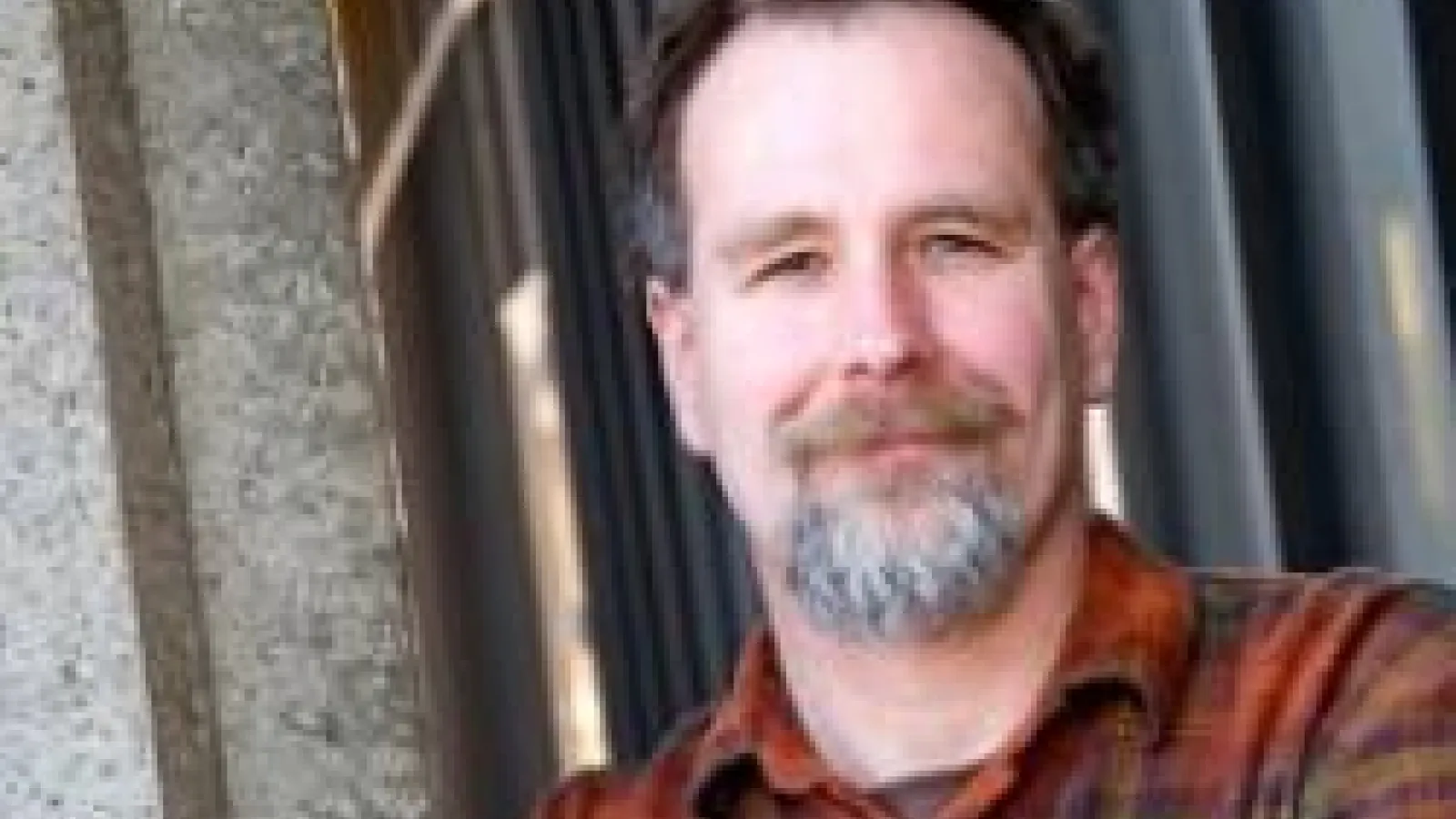 Tom Shutt leaning against a wall.