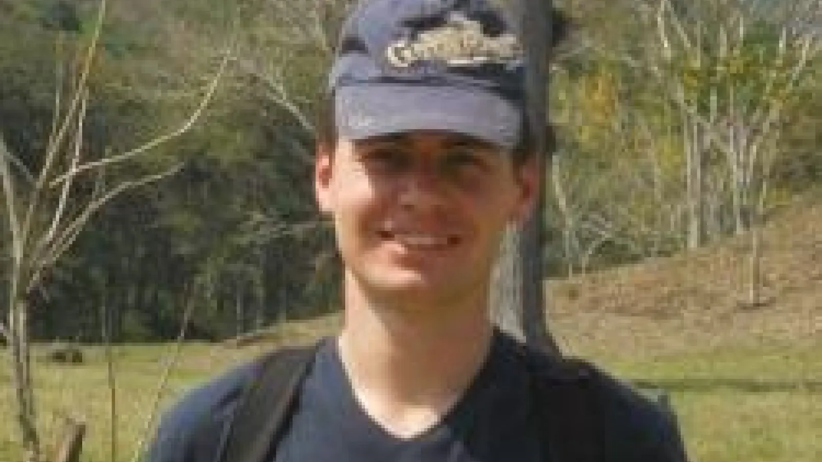 Dmitry Zhuridov standing among sparse trees