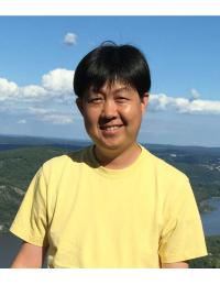 Dr. Inhee Lee Inhee Lee smiling with open landscape and blue sky behind him