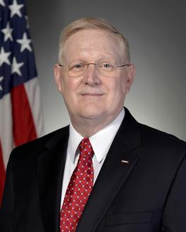 Photo of William P. Roach with American Flag in the background