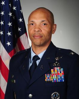 Photo of Colonel Marqus D. Randall in uniform with American Flag in the background.
