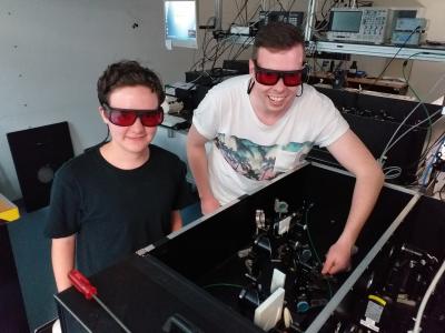 Daniel Pharis and another student next to a laser set up