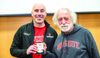 A replica Nobel Prize medal was gifted to chair Michael Poirier and the Department of Physics by Pierre Agostini during the clap-in on March 20, 2024 as a gesture of gratitude and appreciation for his time at The Ohio State University.