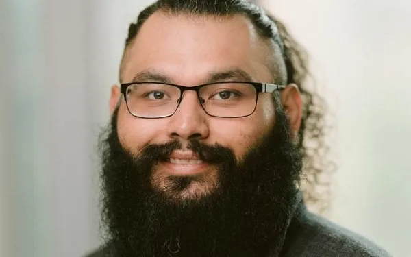 Dennis Calderon headshot with light in the background