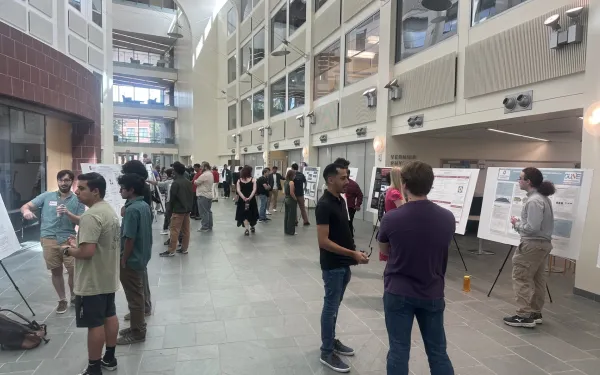 Crowd of people at Atrium showing posters
