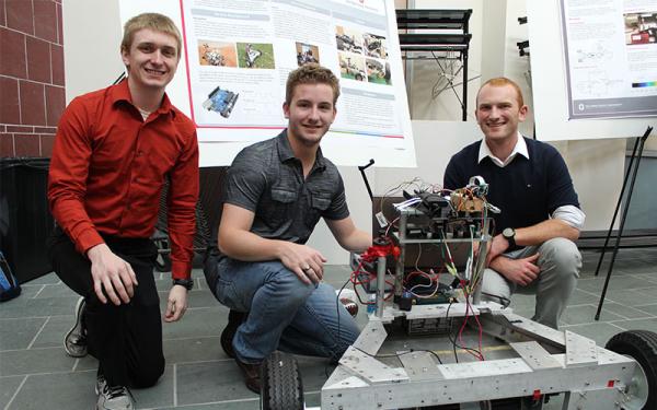 Three Engineering Physics majors posing with their project