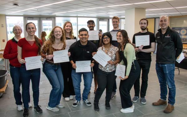grad student award winners holding their certificates