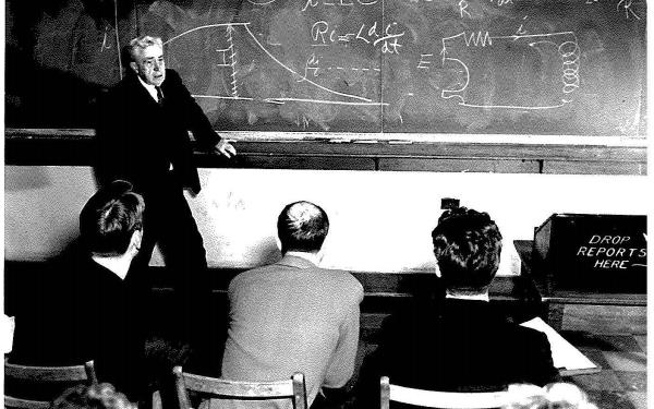 Alpheus Smith lecturing in front of a chalkboard