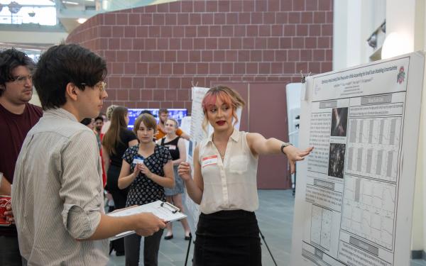 A student presenting her research poster