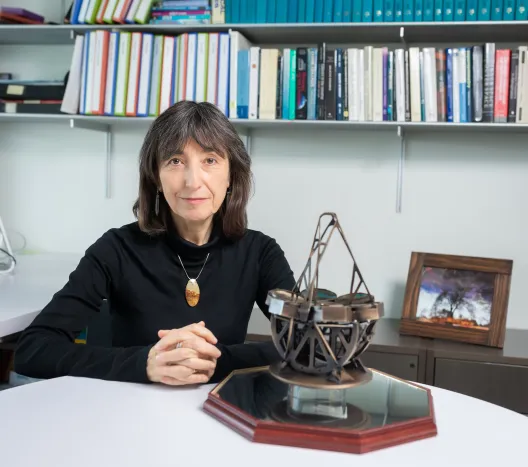 Wendy Freedman sitting at a white table with her hands folded