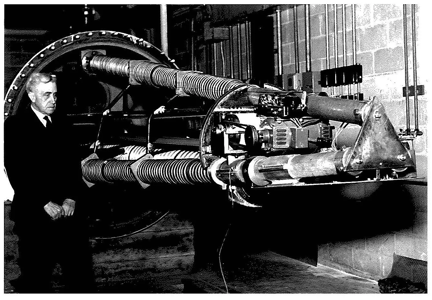 Alpheus Smith standing by a large piece of machinery