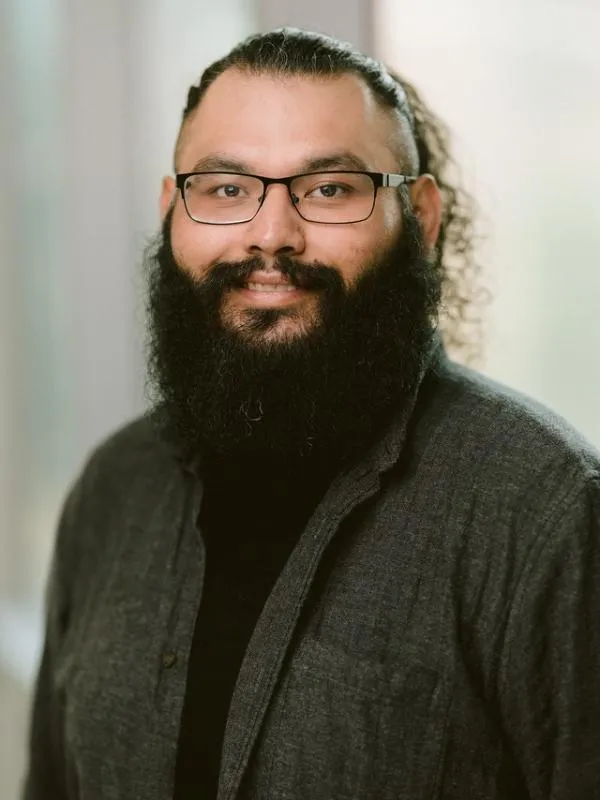 Dennis Calderon headshot with light in the background