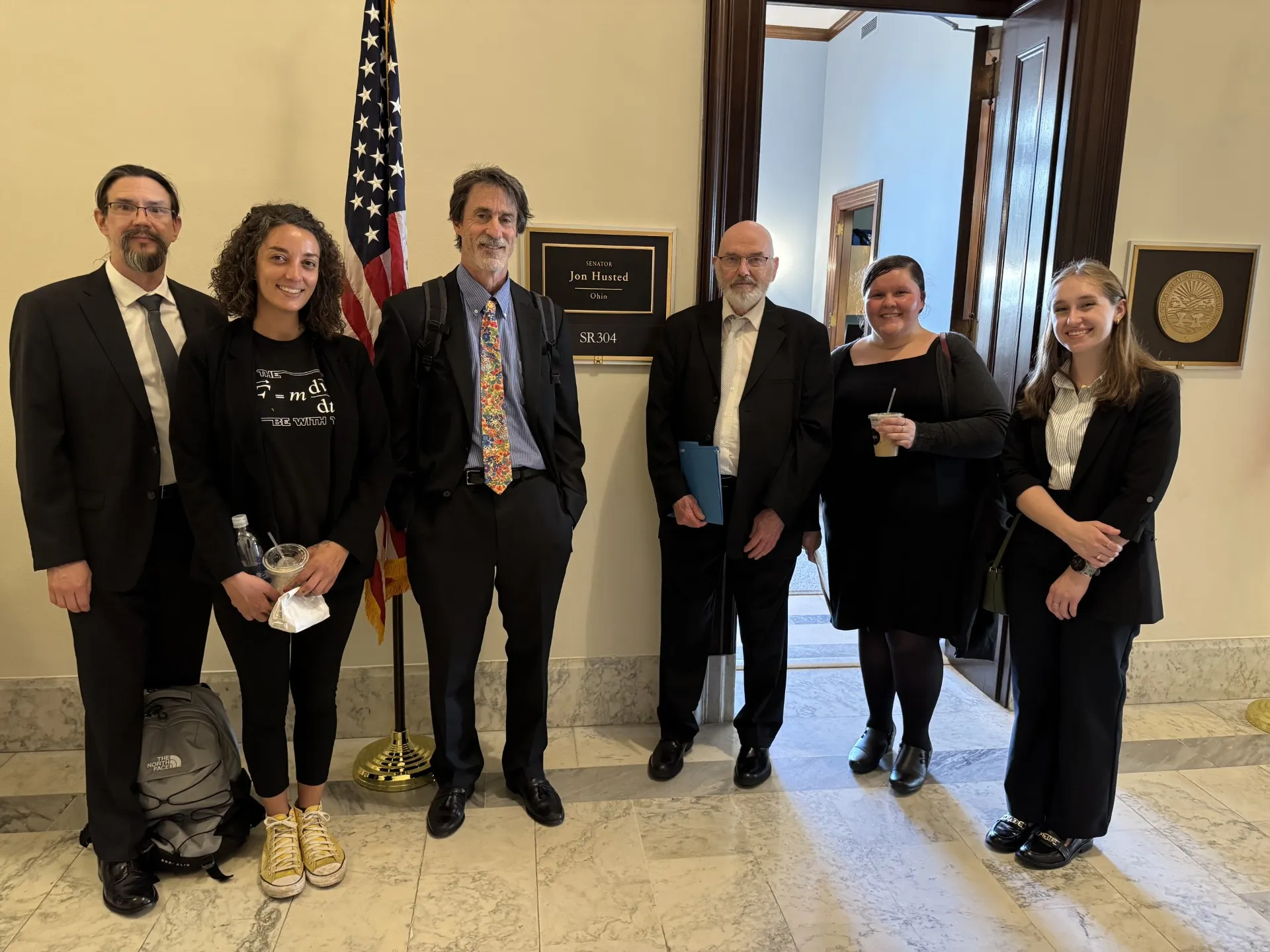 Professor Mike Lisa and student Josie Rose standing in front of senator's office
