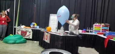 Christine Jackson blowing up a balloon