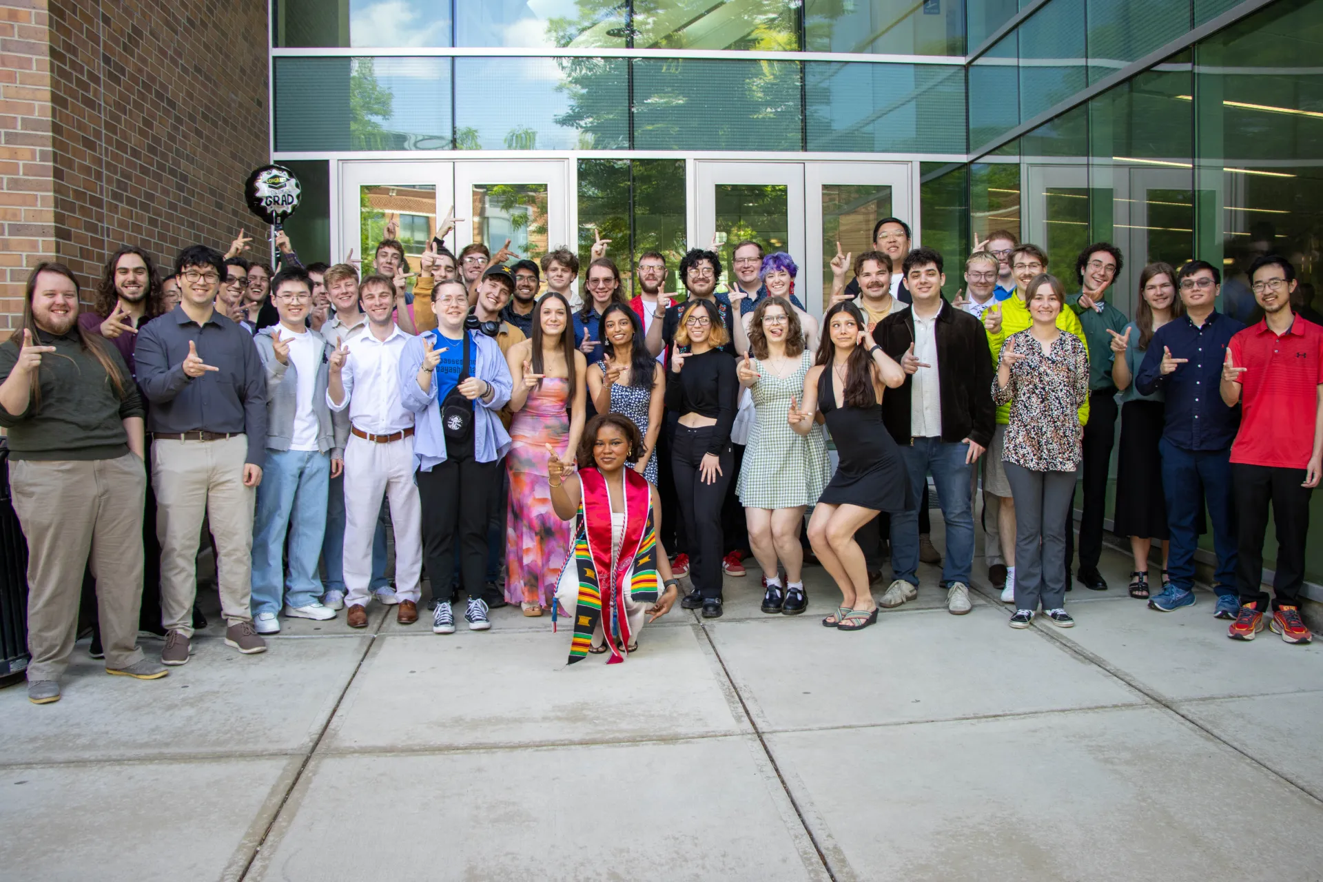 Group Photo of 2025-2026 graduates doing the "right hand rule"