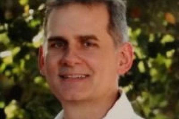 A headshot of Jeff Childress with trees in the background.