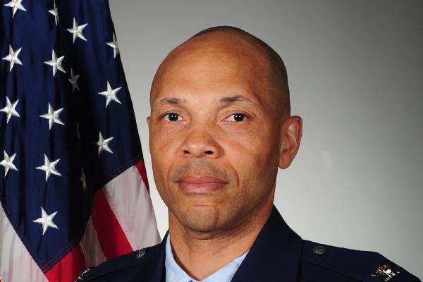Photo of Colonel Marqus D. Randall in uniform with American Flag in the background.