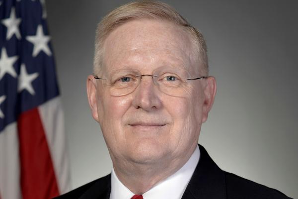 Photo of William P. Roach with American Flag in the background