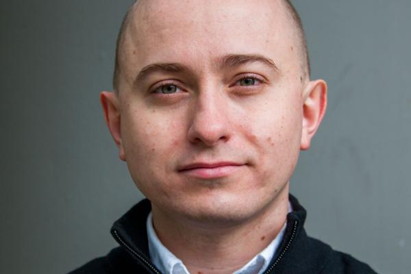 Headshot of Dmitry Ovchinnikov with grey background