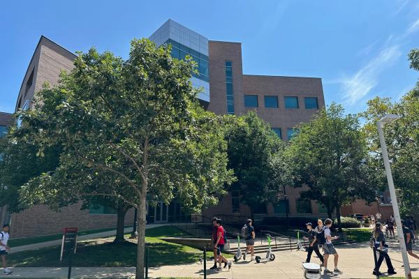 Photo of the outside of the PRB with sun shining and students walking past.