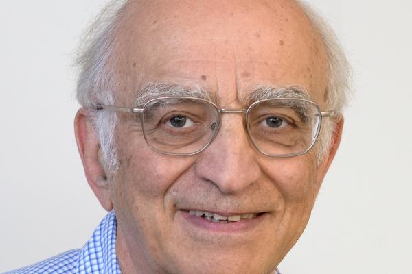 Boris Shklovskii smiling with white background