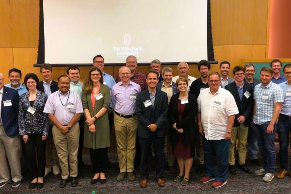 The picture shows a group photo of participants at the workshop.
