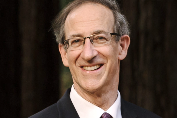 Tony Heinz smiling with trees behind him
