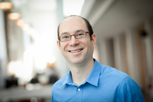 Jeff Moses smiling with blurred background