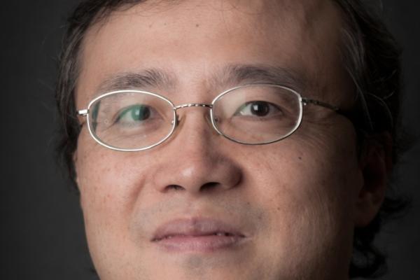 Kun Yang with plain black background