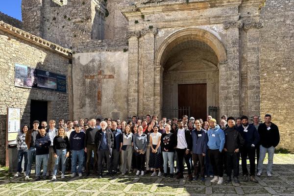 IOS international group members in front of a large stone gate