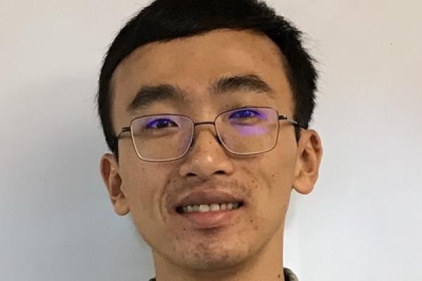 Jung-Tsung's close up with plain white wall behind him