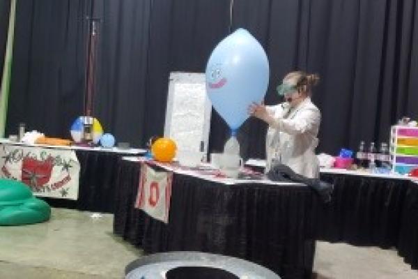 Christine Jackson blowing up a balloon