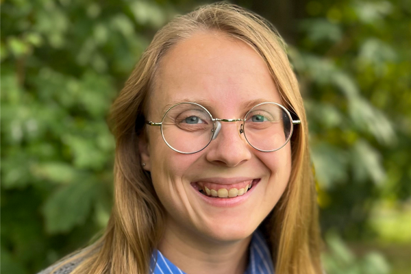 Julie Butler smiling with greenery in the background