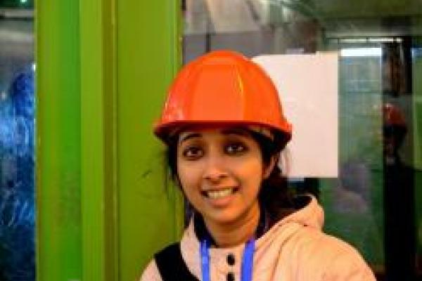 Archana Anandakrishnan smiling in orange hard hat